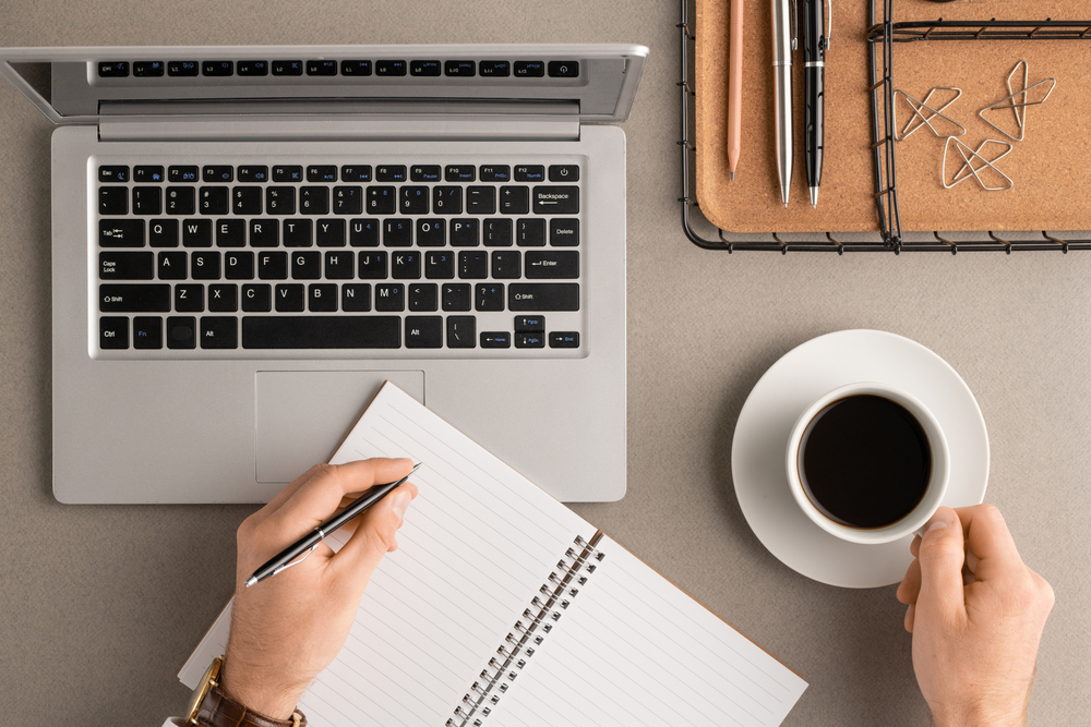 top,view,of,hands,of,young,businessman,with,cup,of